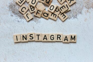 دوراتنا التدريبية Wooden letter blocks arranged to spell 'Instagram' on a textured surface.